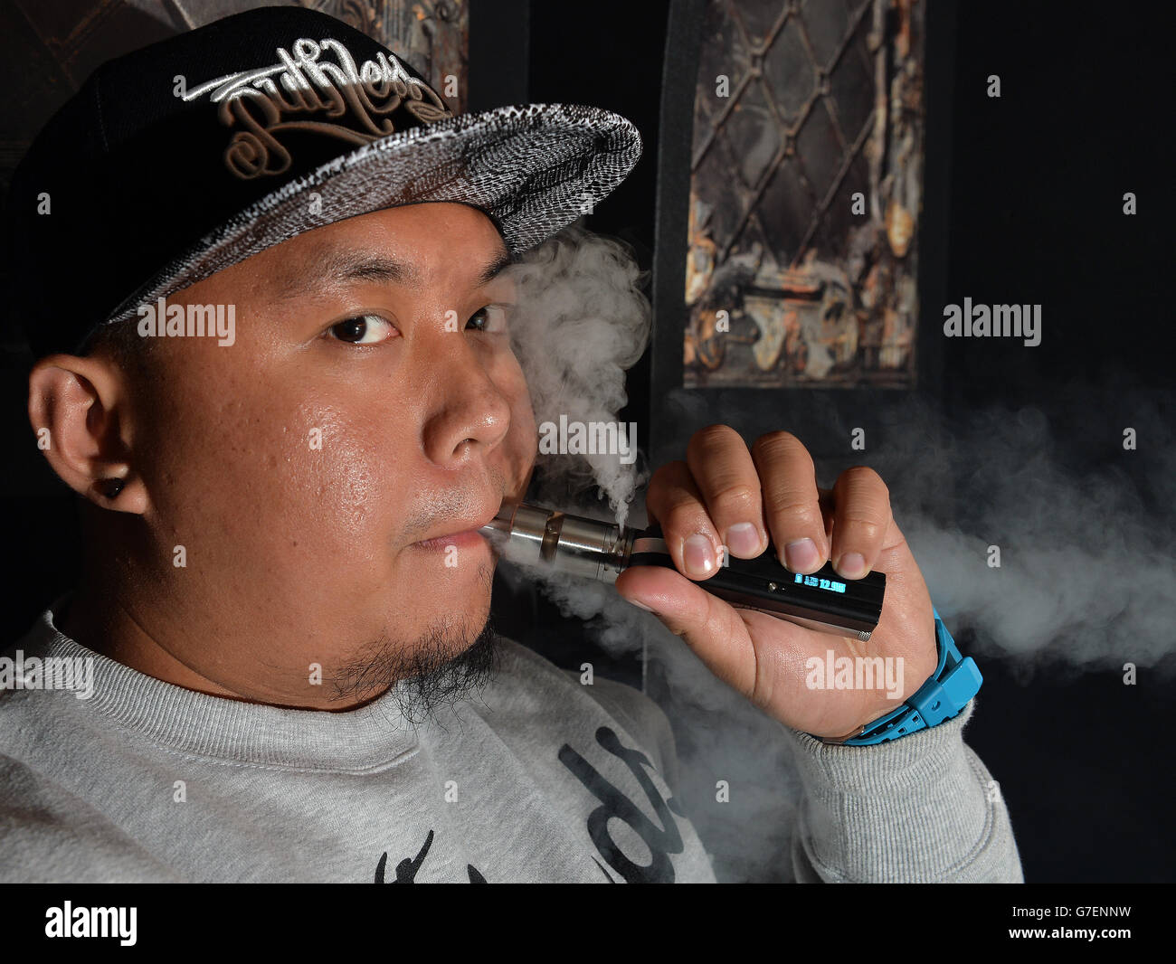 01/11/14 An e-cigarette smoker at the Vape Lab in Shoreditch, east London,  as new figures reveal that electronic cigarettes have been linked to more  than 100 fires in the UK since 2012