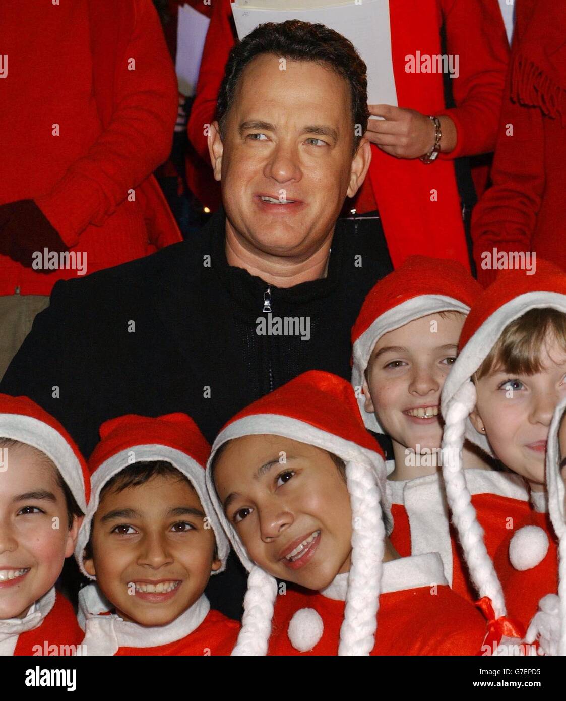 Star of the film Tom Hanks poses with school children as he arrives for the UK premiere of Polar Express, at the Vue Leicester Square in central London. Stock Photo