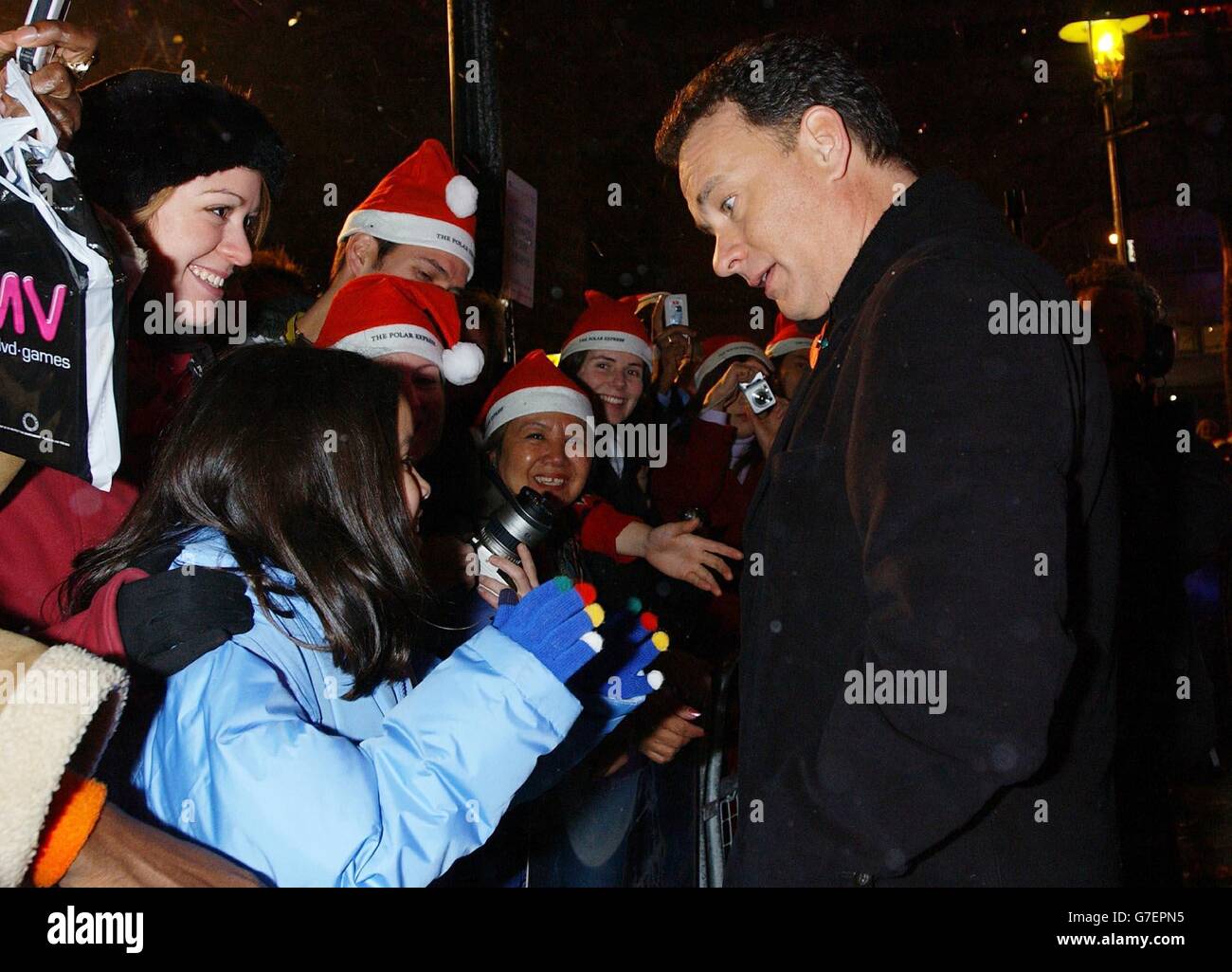 Actor Tom Hanks greets fans as he arrives for the UK premiere of his latest film The Polar Express, at the Vue Leicester Square in central London. Stock Photo