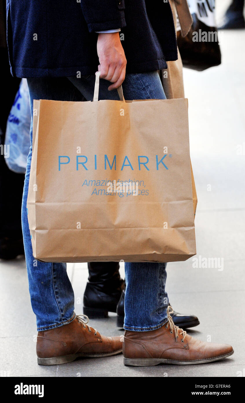 A shopper with Primark bags outside Primark in Oxford Street, central  London Stock Photo - Alamy