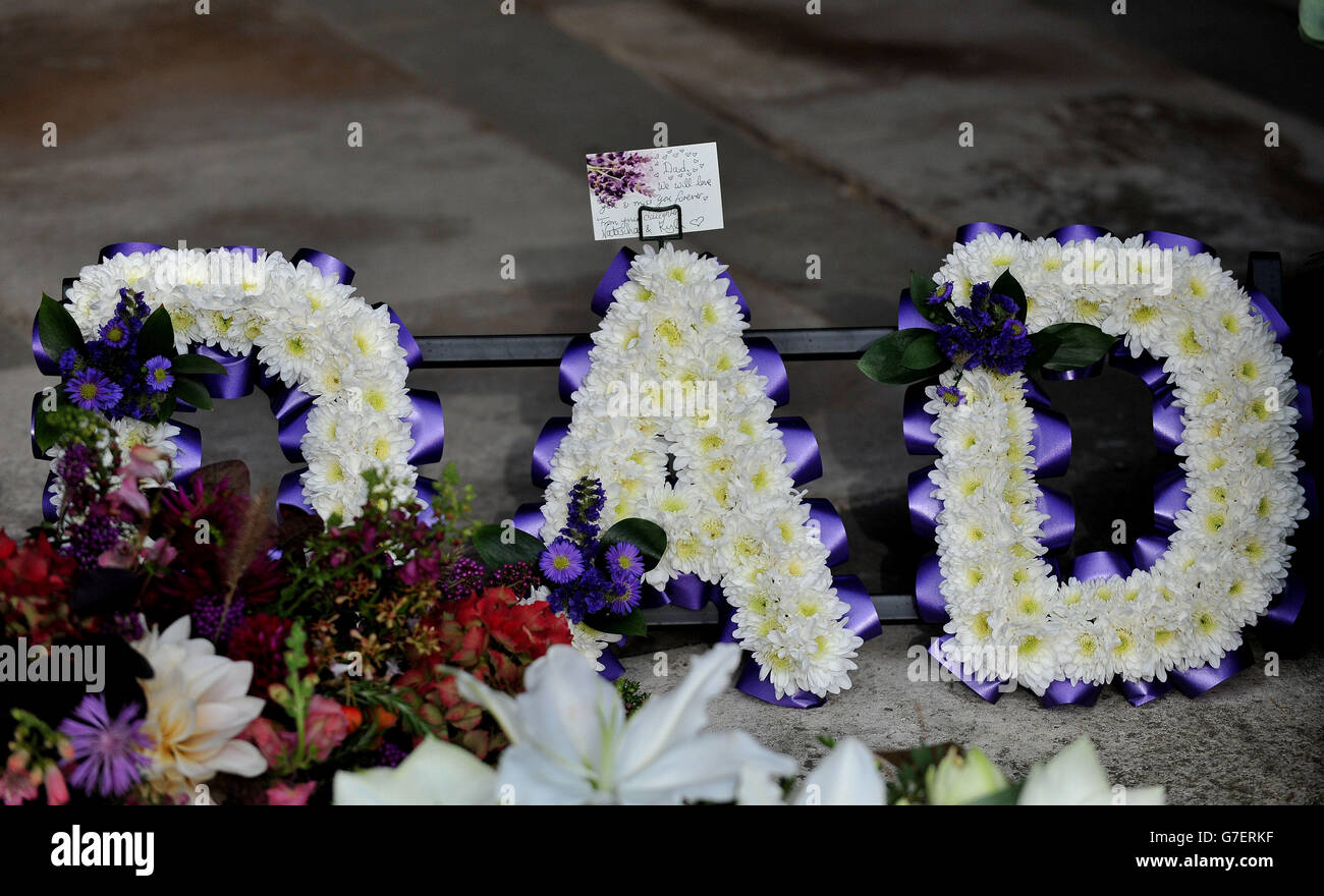 Flowers and a card left by Natasha and Kyla, the daughters of Jack Bruce, following his funeral at Golders Green Crematorium, north west London. Stock Photo