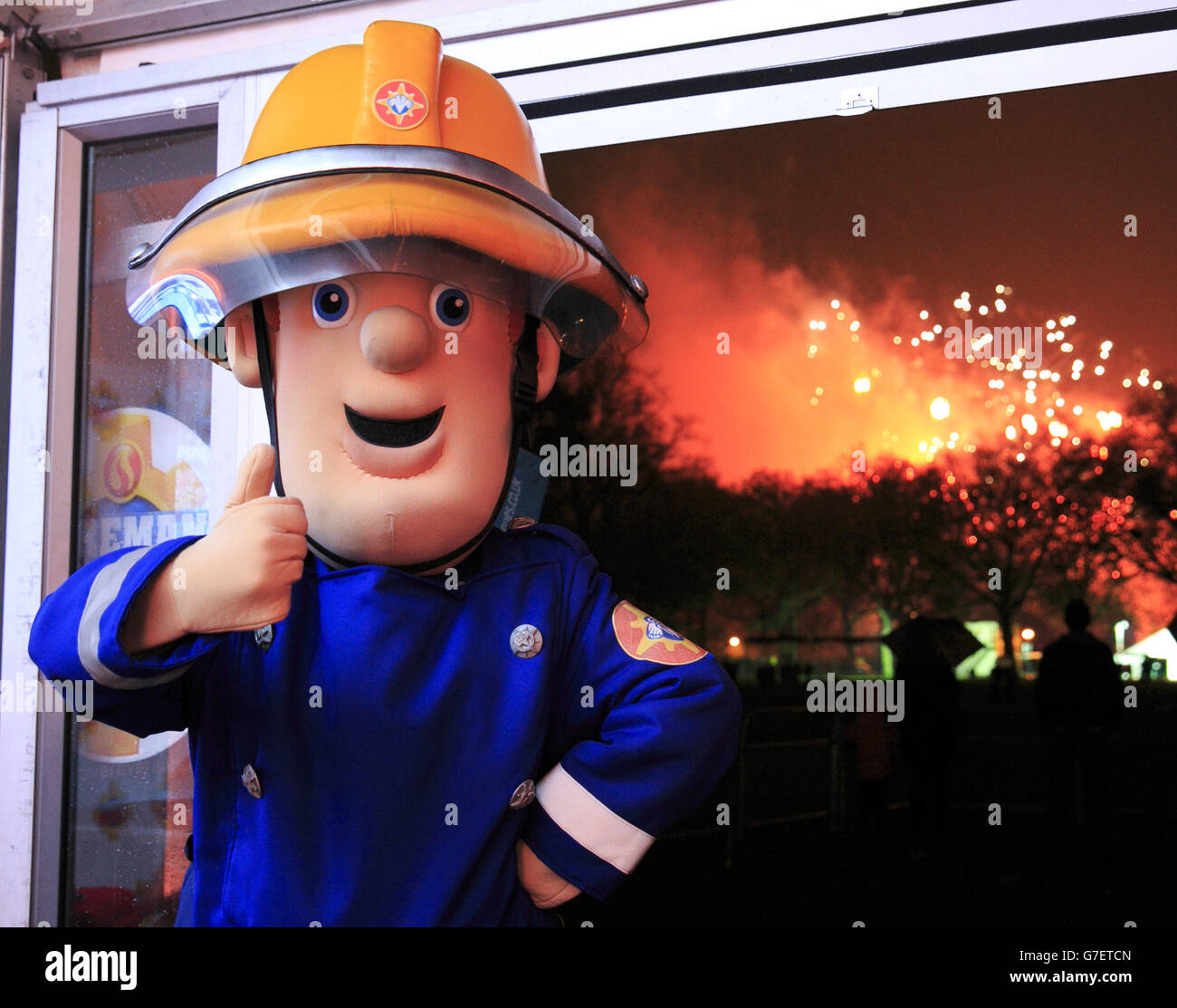 An actor dressed as Fireman Sam attends the Battersea Park fireworks display in south London to promote bonfire safety. Stock Photo