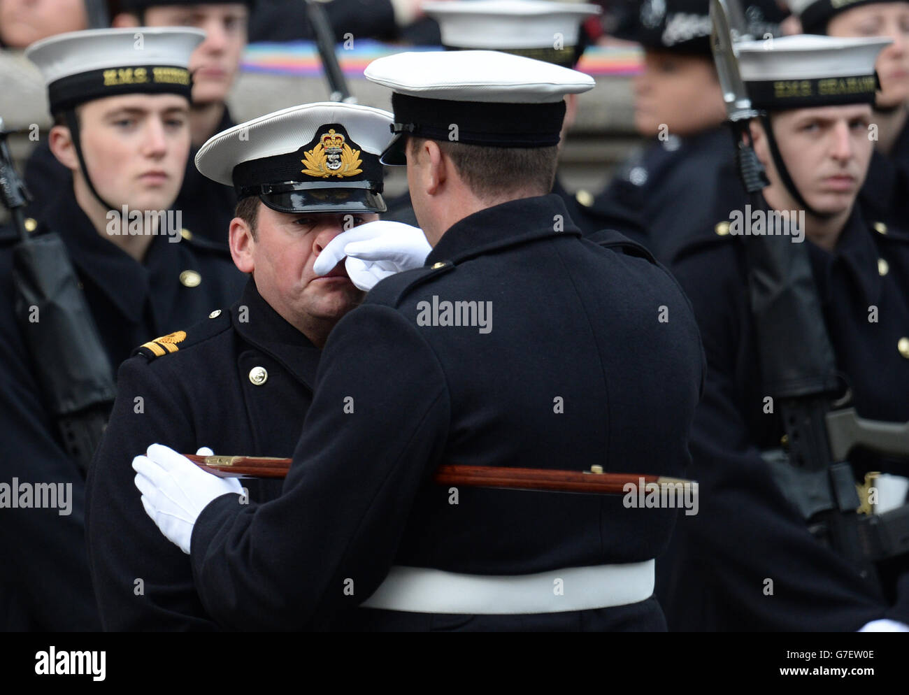 An officer has his nose scratched at the Cenotaph memorial in Whitehall, central London, during the annual Remembrance Sunday service held in tribute for members of the armed forces who have died in major conflicts. Stock Photo