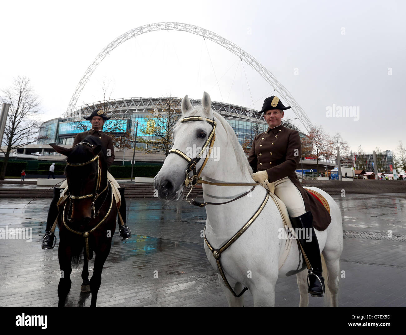 Members of the Spanish Riding School of Vienna Rider Herwig Radnetter (left) riding Pluto Sambata and First Chief Rider Wolfgang Eder with his horse Pluto Malina pose in front of Wembley Stadium in west London where the riding school are performing at Wembley Arena from Friday to Sunday. Stock Photo