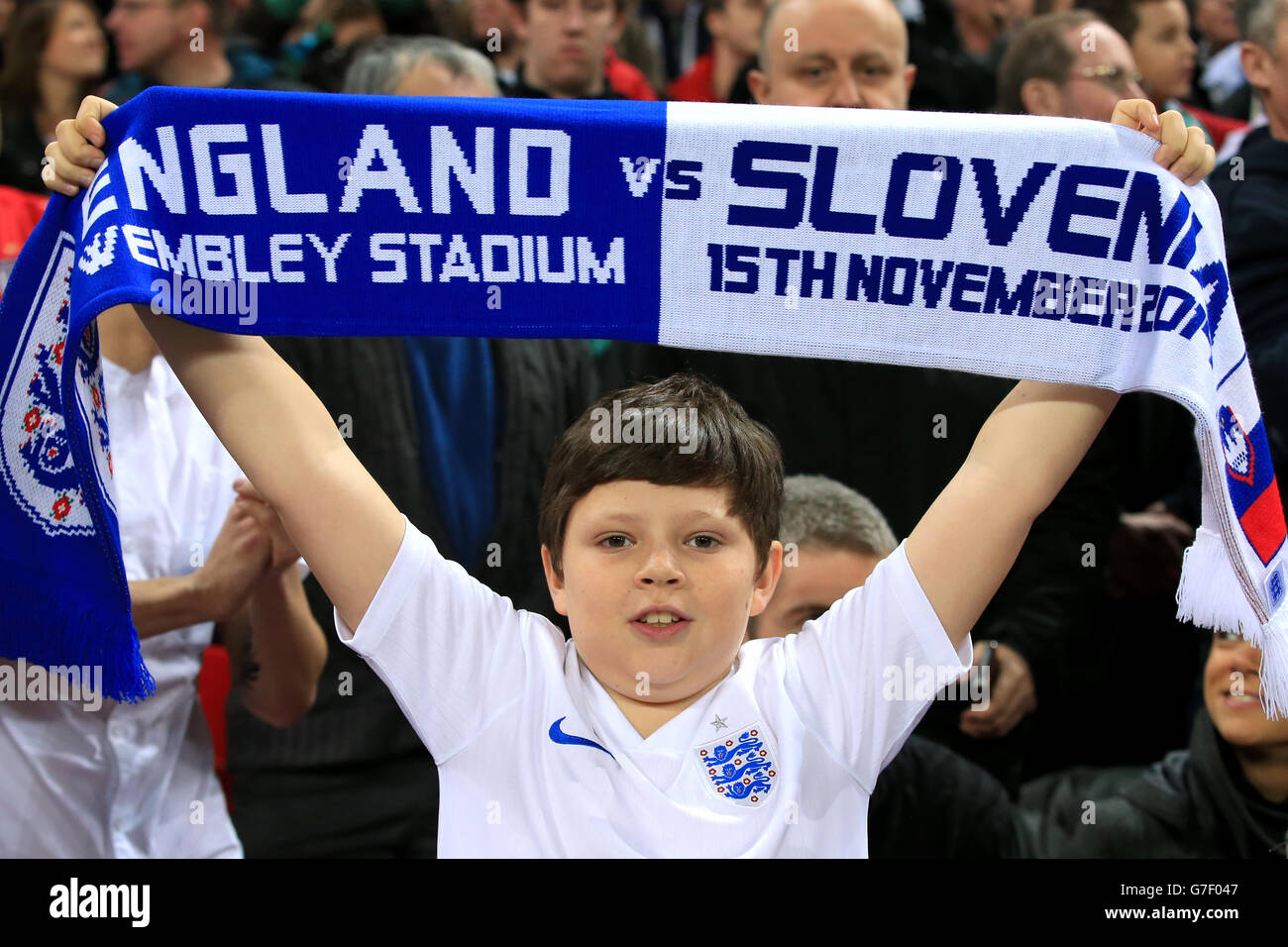 A young England fan shows his support in the stands before the UEFA Euro 2016 Group E Qualifying match at Wembley Stadium, London. PRESS ASSOCIATION Photo. Picture date: Saturday November 15, 2014. See PA story SOCCER England. Photo credit should read: Nick Potts/PA Wire. No editing except cropping. Call +44 (0)1158 447447 or see www.paphotos.com/info/ for full restrictions and further information Stock Photo