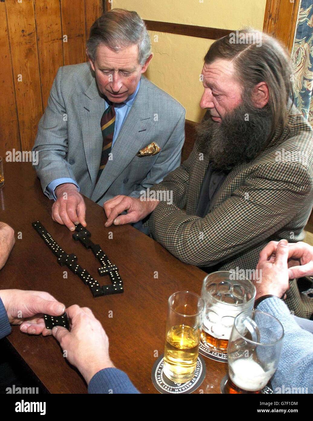 The Prince of Wales plays dominoes in the Farmers Arms Pub in Muker, Swaledale, during his visit to the village. Stock Photo