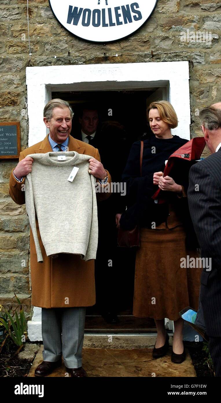 The Prince of Wales tries a woollen sweater he was presented with during his visit to Swaledale Woollens in Muker, Swaledale, during his visit to the village. Stock Photo