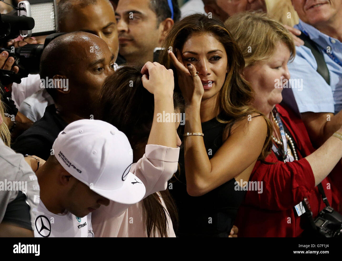 Nicole Scherzinger wipes away a tear after Lewis Hamilton becomes World Champion after victory in the 2014 Abu Dhabi Grand Prix at the Yas Marina Circuit, Abu Dhabi, United Arab Emirates. Stock Photo