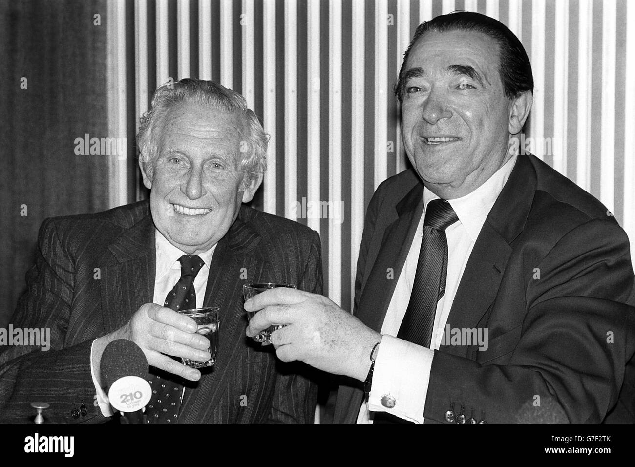 Robert Maxwell, chairman of Oxford United, and Frank Waller, chairman of Reading, drink a toast to the future of their clubs merger at Lancaster Gate headquarters of the Football Association. Oxford's formal offer to buy shares of it's third division neighbours is expected to be posted before the end of the month. A possible name for th enew club is Thames Valley United. Stock Photo