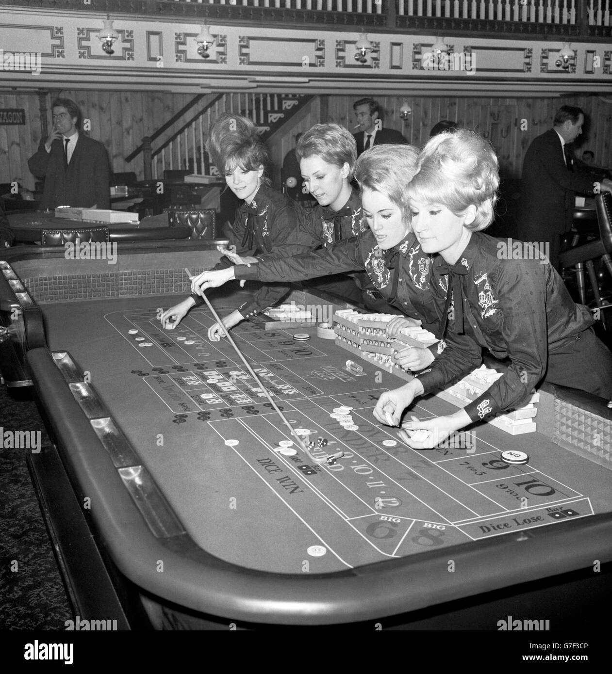 Croupiers at the dice table on the opening night of the Maverick Club in Peckham High Street, which is modelled on an American mid-West gambling saloon of the last century. (l-r) Pat Andrew, of London, Susan Dorrington, of Rochester, Penny Slade, of London, and Shirley Brewin, of St Mary Cray. Stock Photo