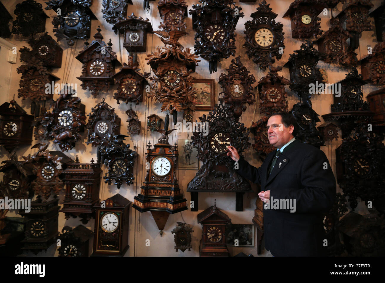 Horologist Roman Piekarski starts the time consuming task of adjusting the antique clocks at Cuckooland Museum in Tabley, as he prepares for the clocks to go back an hour on Sunday morning, at the end of British Summer Time. Stock Photo