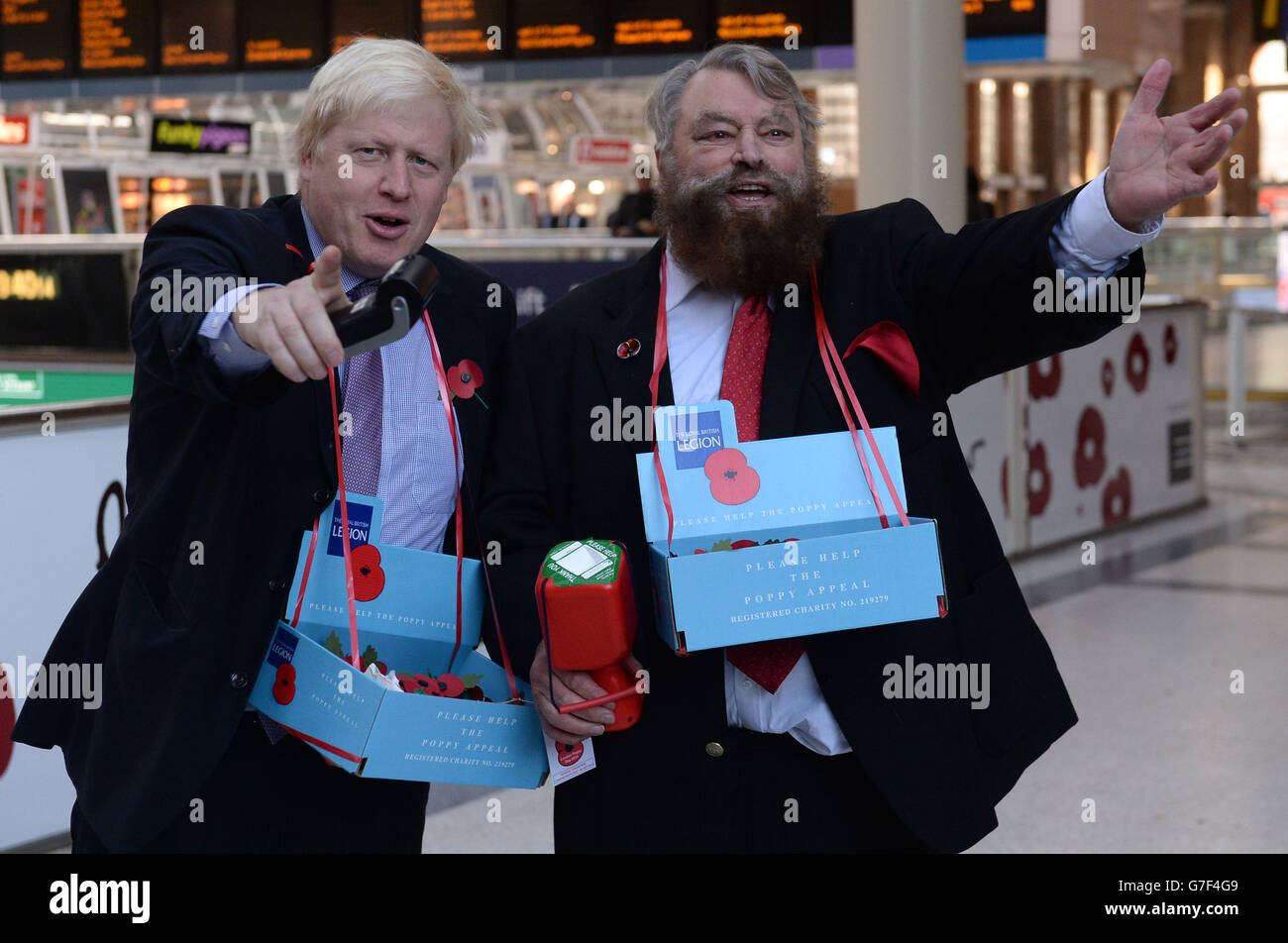 The Mayor of London Boris Johnson (left) and actor Brian Blessed sell poppies in Liverpool Street Station in central London. Stock Photo