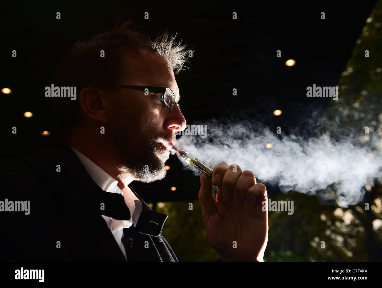 A man smoking an electronic cigarette (variously known as an e