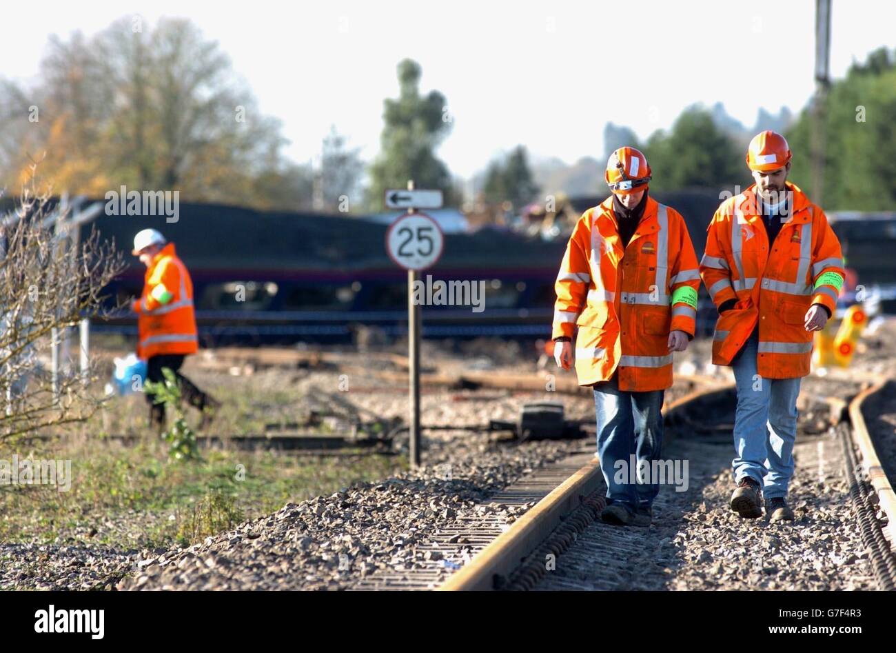 Engineers work on the railway line that Saturday's 17.35 from London Paddington to Plymouth travelled along, shot from the level crossing where the train hit the vehicle of Brian Drysdale that he had parked there, at Ufton Nervet in Berkshire. The crash, which has claimed seven lives, including that of Mr Drysdale, occurred on Saturday evening soon after the train had left Reading bound for Plymouth. Stock Photo
