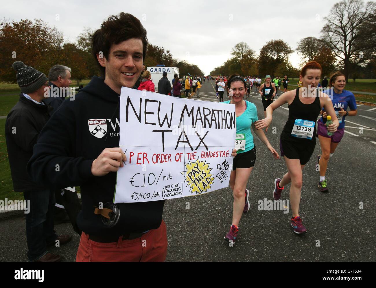 PHOTO. Oisin Kenny attempts to implement a marathon tax as runners make their way through Phoenix Park as more than 14,000 people took part in the 35th Dublin City marathon in Dublin, Ireland. Stock Photo