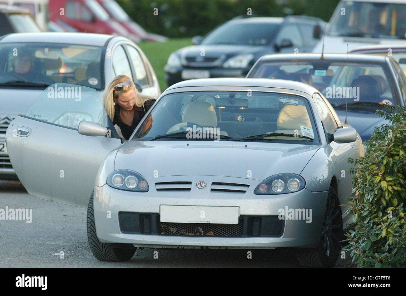 Zara Phillips Cheltenham. Zara Phillips climbs into the drivers seat of a  sports car as she leaves Cheltenham Races Stock Photo - Alamy