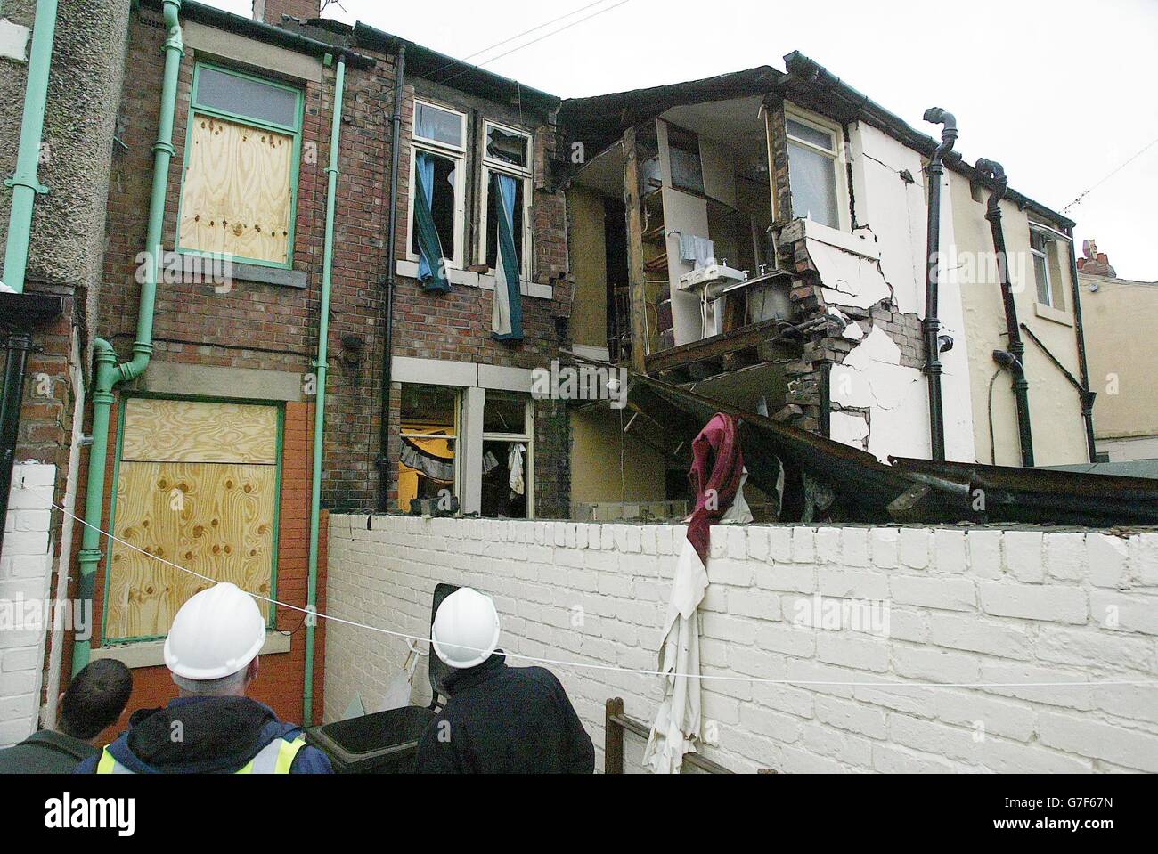 A 93-year-old woman was burned in a gas explosion which destroyed her home, a fire brigade spokeswoman said today. The pensioner suffered head injuries and burns to her face, legs and arms in the huge blast at her home in Sackville Road, Heaton, Newcastle. Workmen look at the scene in Newcastle. Stock Photo