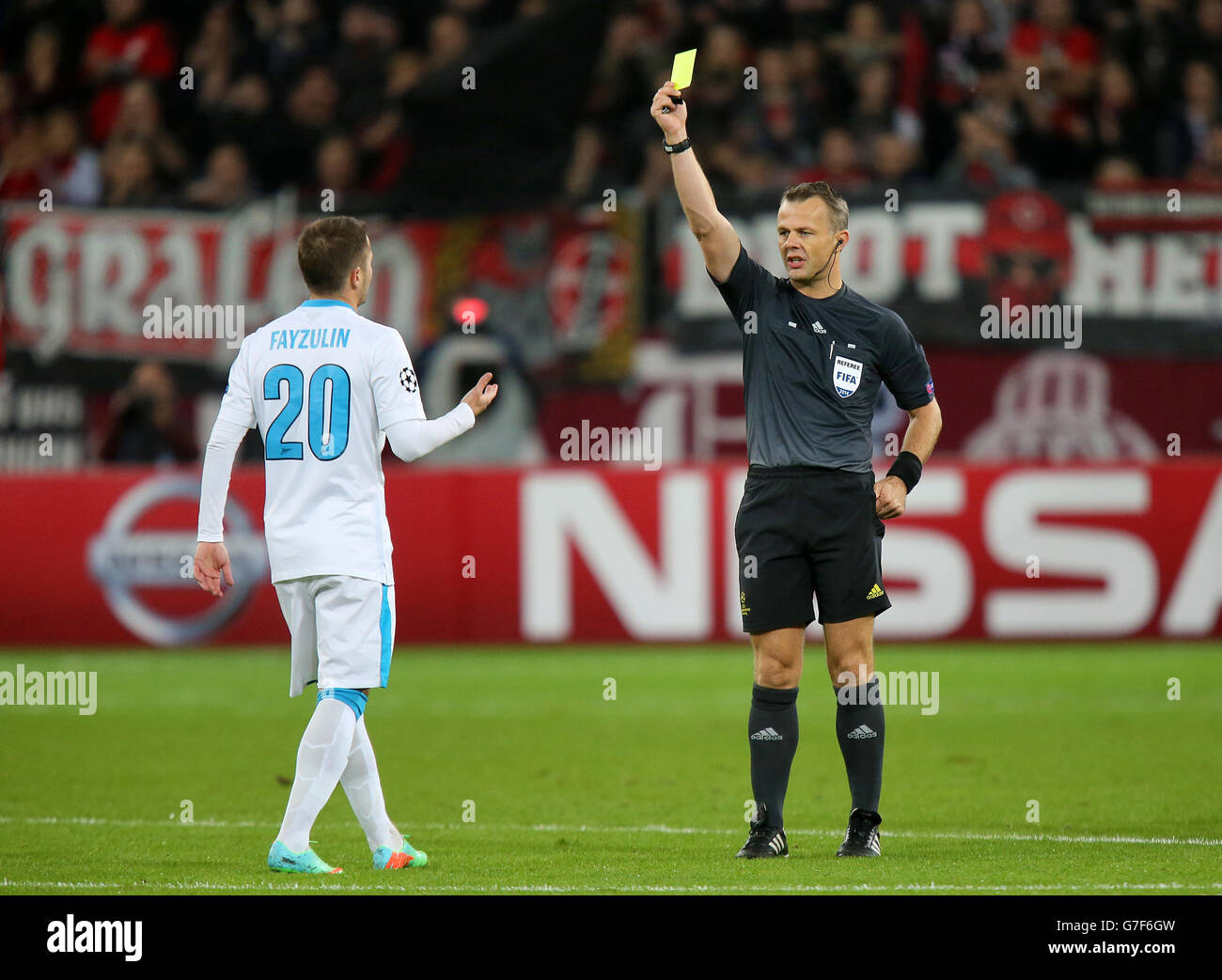 Referee Bjorn Kuipers shows a yellow card to Zenit Saint Petersburg's Viktor Fayzulin. Stock Photo