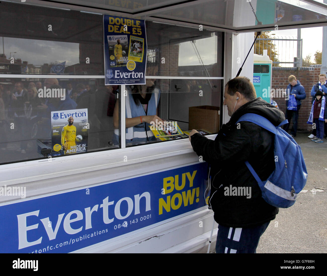 Soccer - Barclays Premier League - Everton v Swansea City - Goodison Park. An Everton fan buys a match day program Stock Photo