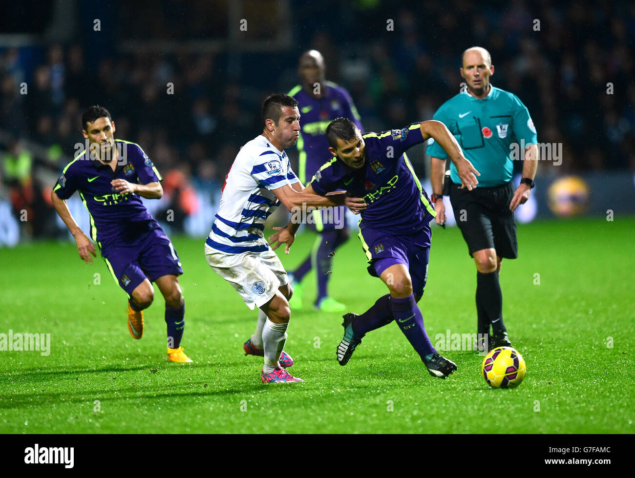 Queens Park Rangers' Mauricio Isla and Manchester City's Sergio Aguero battle for the ball during the Barclays Premier League match at Loftus Road, London. Stock Photo