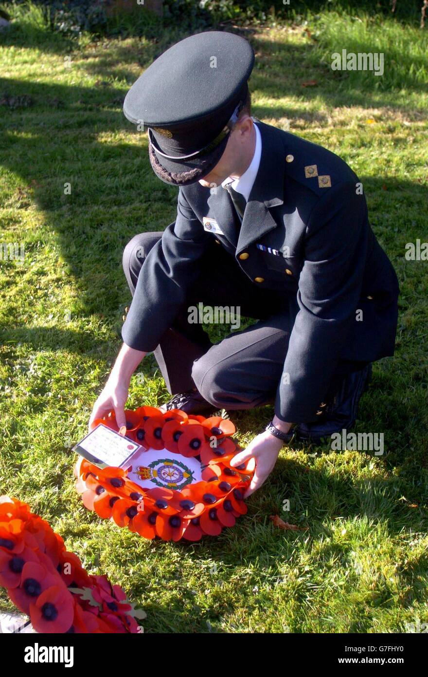 Stephen Hines, from the London Ambulance Service, lays a wreath in memory of the seven lives lost at the Ufton Nervet rail crash during a special service of remembrance held at St Mary's Church in Sulhamstead Abbots near Ufton Nervet in Berkshire. The Rememberance Sunday service honoured those lives lost at the Ufton Nervet rail crash which happened last Saturday. Stock Photo