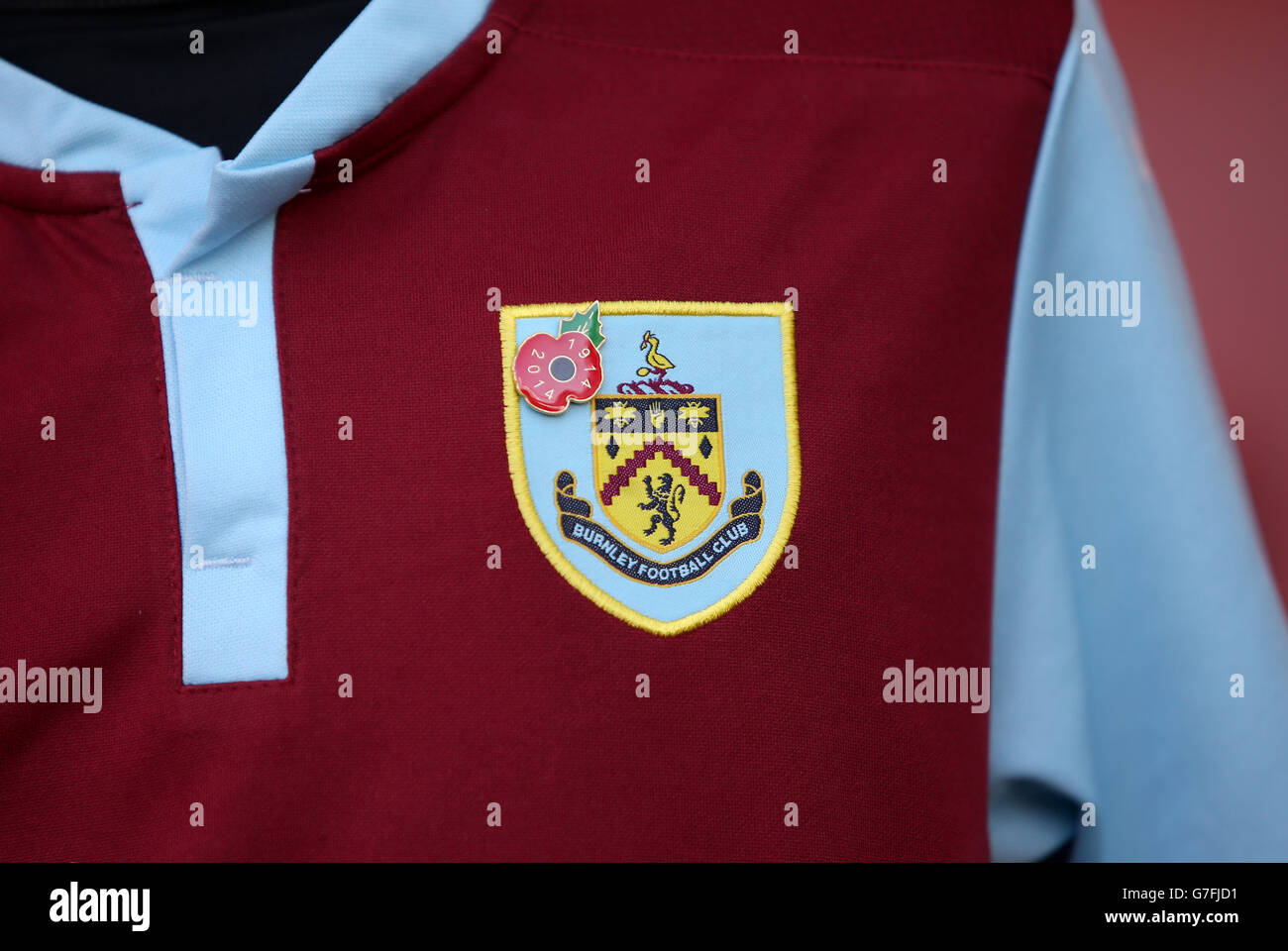 Soccer - Barclays Premier League - Arsenal v Burnley - Emirates Stadium. The badge and poppy on a Burnley fan's shirt Stock Photo