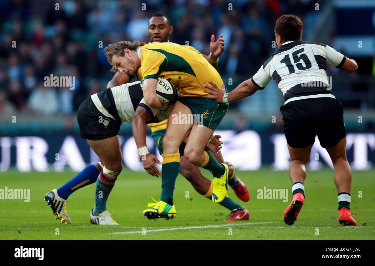 Australia's Rob Horne is tackled by Barbarians Francis Saili and Tim Nanai-Williams during the Killik Cup match at Twickenham, London. Stock Photo