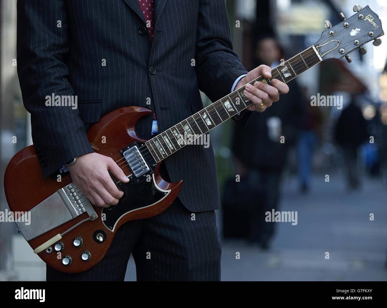 A Gibson SG guitar estimated at $500, 000 US, 300,000 stirling, is played on London's Old Brompton road. Stock Photo