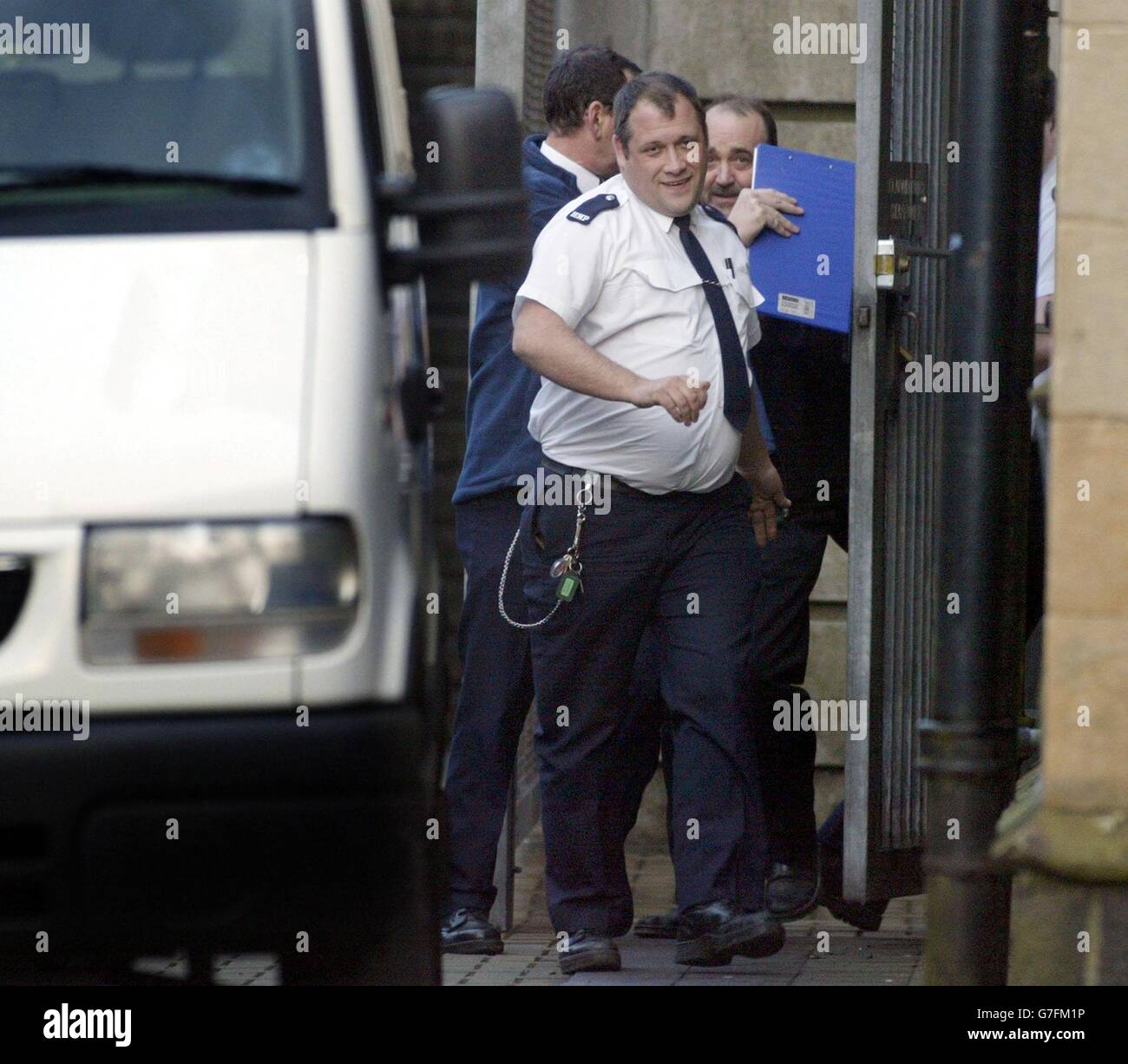 Ex-Policeman William Coulter, 52, (right) is led away by prison officers from Antrim Crown Court, sitting in Ballymena, Co Antrim to start an 18 year jail sentence for the murder of his partner, mother of two Gillian Doherty, 43, who was stabbed at the Portstewart home they shared. Stock Photo