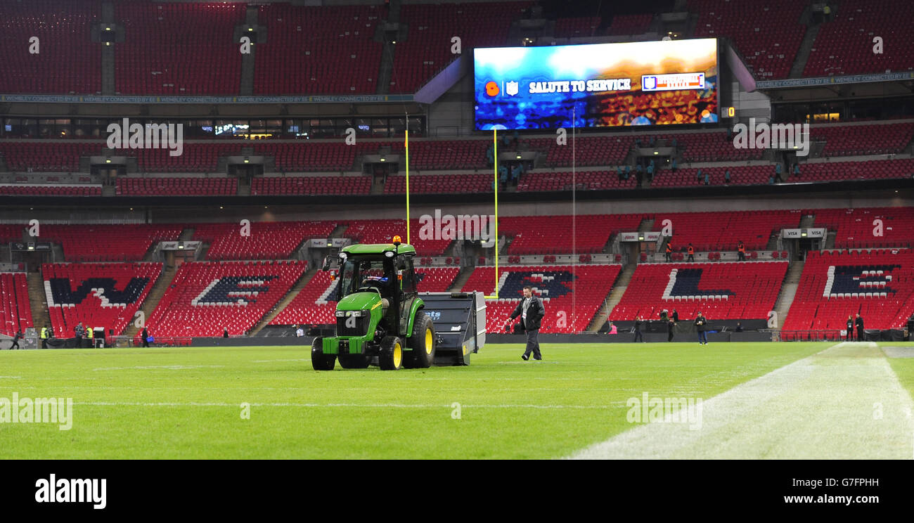 Groundsmen cut the grass on the pitch after the NFL International match at Wembley Stadium, London. Picture date: Sunday November 9, 2014. See PA story GRIDIRON NFL. Photo credit should read: Andrew Matthews/PA Wire. RESTRICTIONS: News and . Commercial/Non-Editorial use requires prior written permission from the NFL. Digital use subject to reasonable number restriction and no video simulation of game. For further info please call +44 (0)115 8447447. Stock Photo