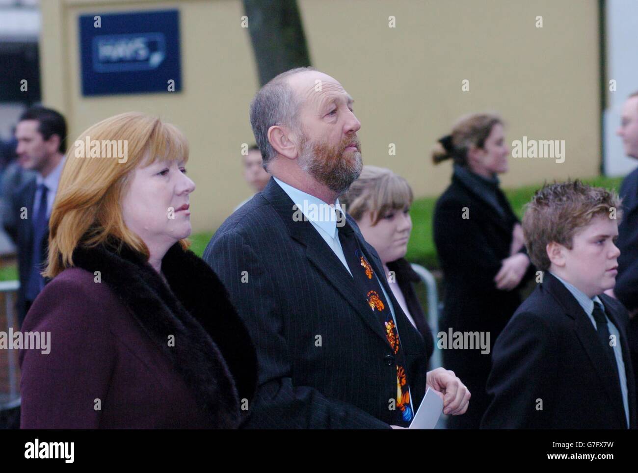 Deborah Martin (L) arrives with her children Louise (centre-back), 13, and James (R), 15, and an unidentified man at the Memorial Service for last month's Berkshire rail crash, at the Minister Church of St Mary in Reading. Louise's husband Stanley had been driving the train which collided with a motor vehicle, and was killed along with six others. Stock Photo