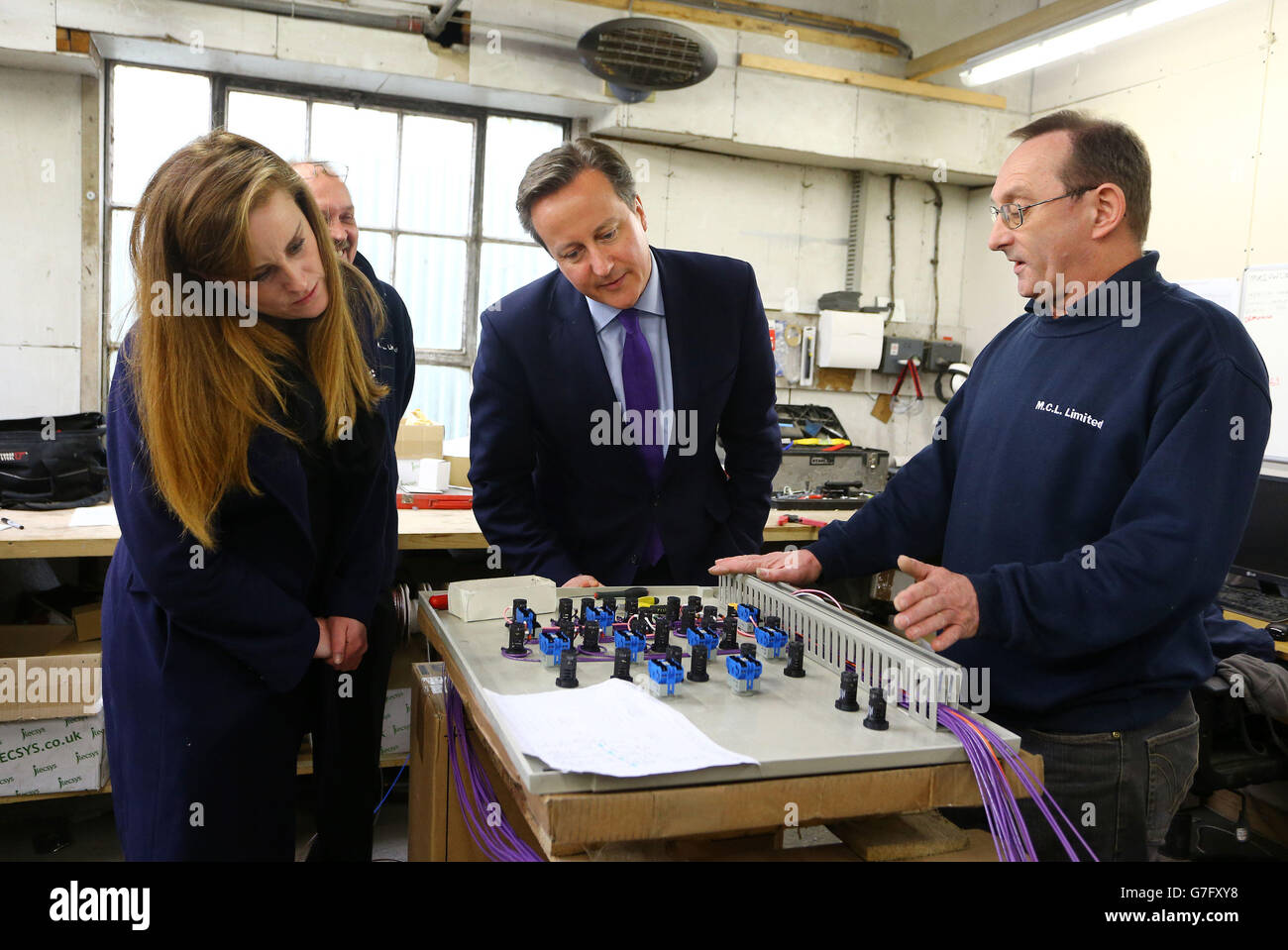 Prime Minister David Cameron with Kelly Tolhurst (left) Conservative Candidate for Rochester and Strood, talk to Mick Parks, Workshop Foreman at MCL Mechanical near Rochester, Kent, during a constituency visit ahead of the forthcoming by-election later this week. Stock Photo