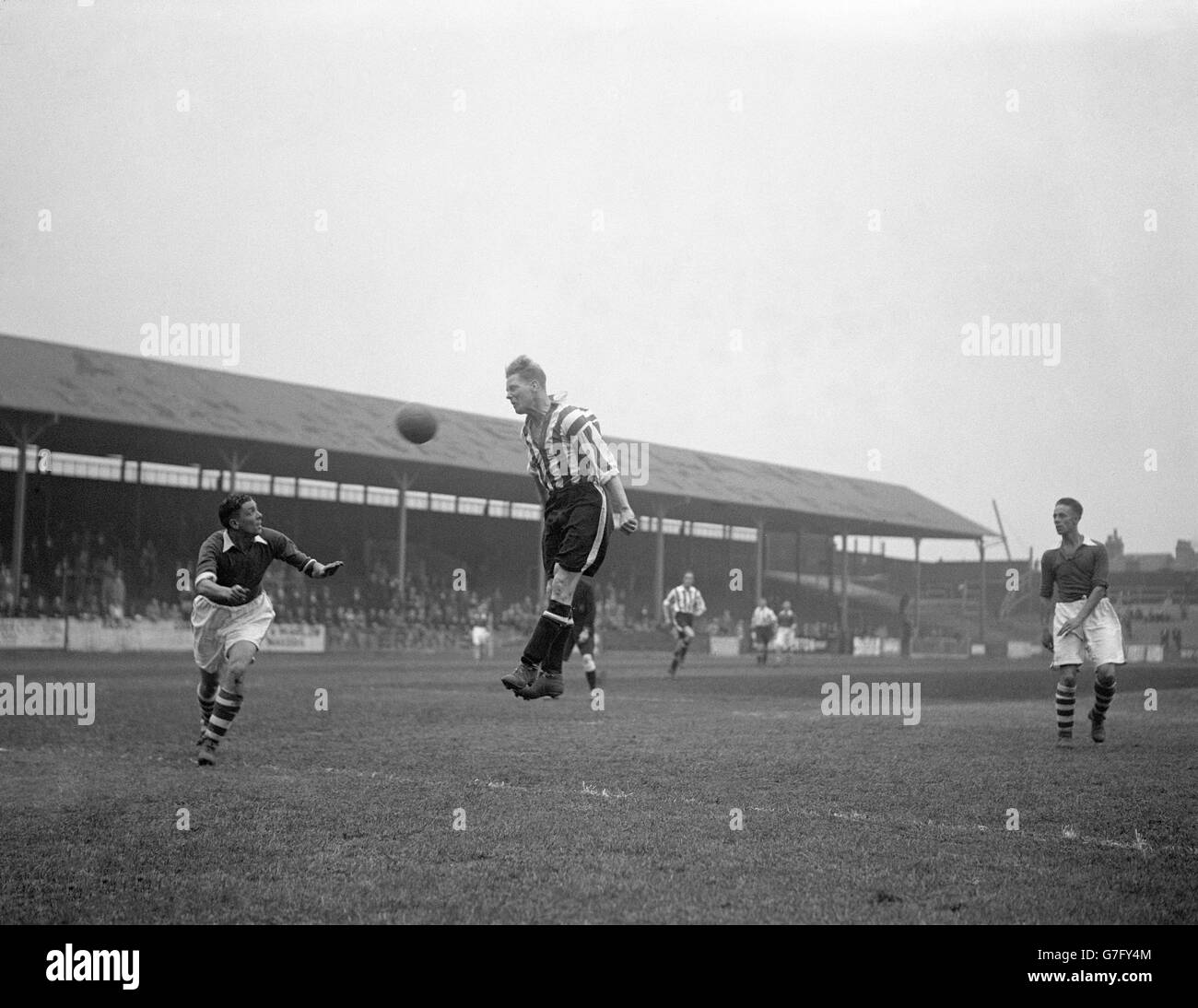 Millwall's Gilbert Wassell (l) watches as Brentford's George Bumbrell wins a header. Stock Photo