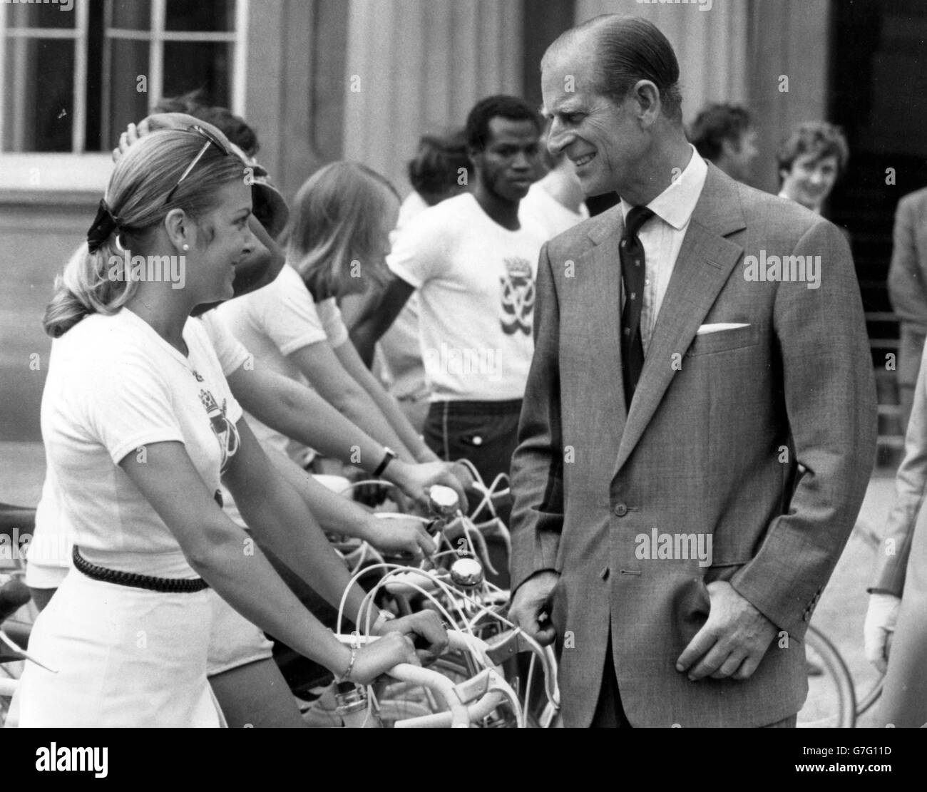 Prince Philip talks with 19-year-old Kim Turner, of London, in the quadrangle of Buckingham Palace before she set off with eight other riders - several of them Duke of Edinburgh Gold Award winners - for a sponsored cycle ride to Windsor Castle to start off the award scheme's fund-raising event of 1975. *Scanned low-res from print, high-res available on request* Stock Photo