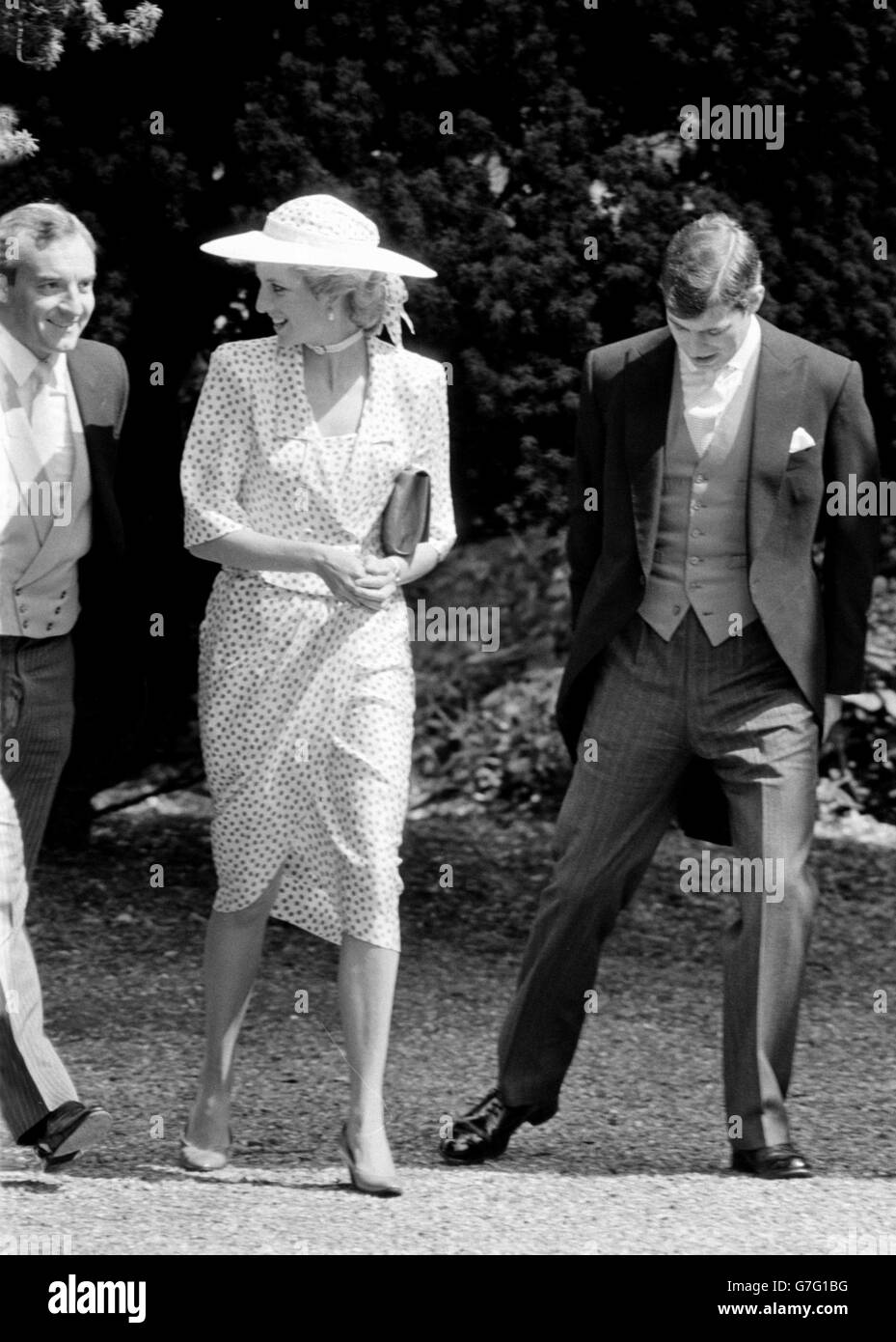 1985: The Princess of Wales, wearing a pink spotted silk suit and brimmed white hat, smiles at her police bodyguard, Barry Mannakee, as she arrives at Highclere, Berkshire, for the wedding of the Hon. Carolyn Herbert to bloodstock agent John Warren. 30/11/2004 The Princess of Wales, smiles at her police bodyguard, Barry Mannakee, as she arrives at Highclere, Berkshire, for the wedding of the Hon. Carolyn Herbert to bloodstock agent John Warren: Princess Diana believed that one of her lovers was 'bumped off', according to tapes being broadcast for the first time tonight in the United States. Stock Photo