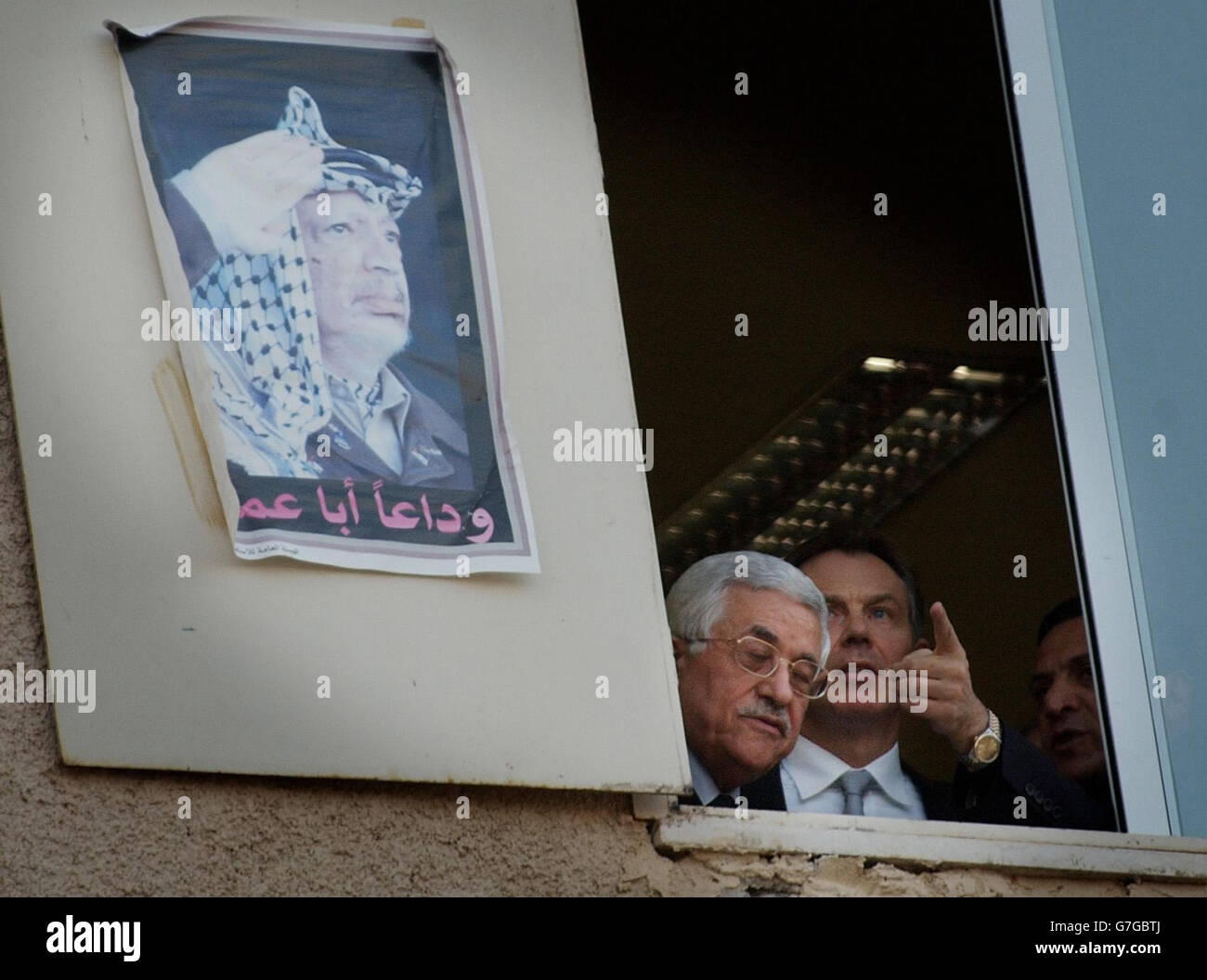Tony Blair looks out of a window at The Mukataa, the Presidential Compound of the Palestinian Authority when he visited Mahmoud Abbas, (left) Chairman of the PLO. Mr Blair held talks with key Palestinian figures and said he had a 'sense of hope' that the deadlock in the Middle East could be broken. Stock Photo