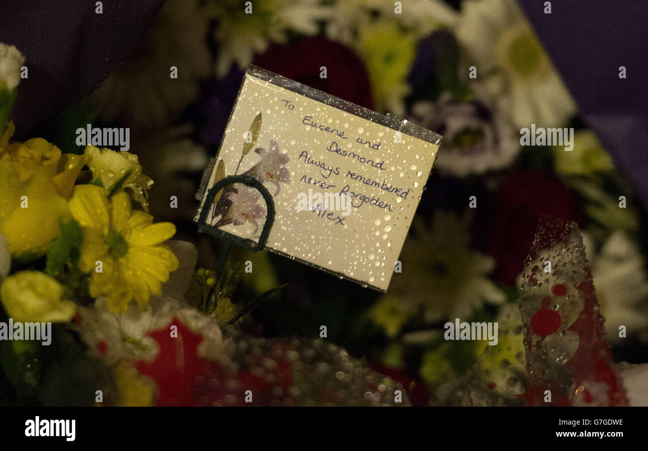 A card and flowers are left during a memorial service at St Philip's Cathedral, Birmingham, for the 21 people who died in the Birmingham pub bombings in 1974. Stock Photo