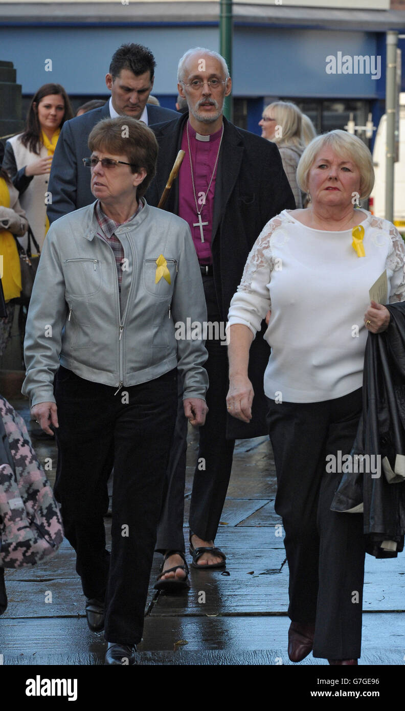 The Bishop of Manchester, The Rt Revd David Walker (centre) arrives with other mourners at a memorial service for murdered British aid worker Alan Henning at Eccles Parish Church in Manchester. Stock Photo