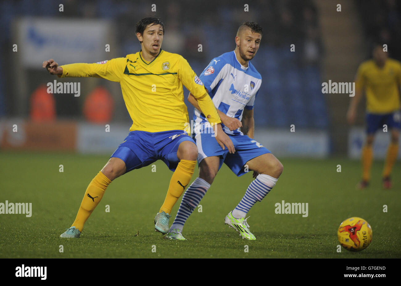 Coventry City's Jack Finch is challenged by Colchester United's