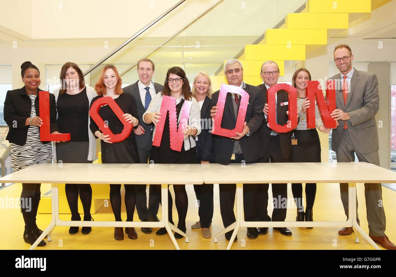 President and Chief Executive Officer of the LEGO Group, Jorgen Vig Knudstorp (far right), and the LEGO Group owner Kjeld Kirk Kristiansen (third from right) with members of the London team at the opening of the LEGO Group's new office in central London. Stock Photo