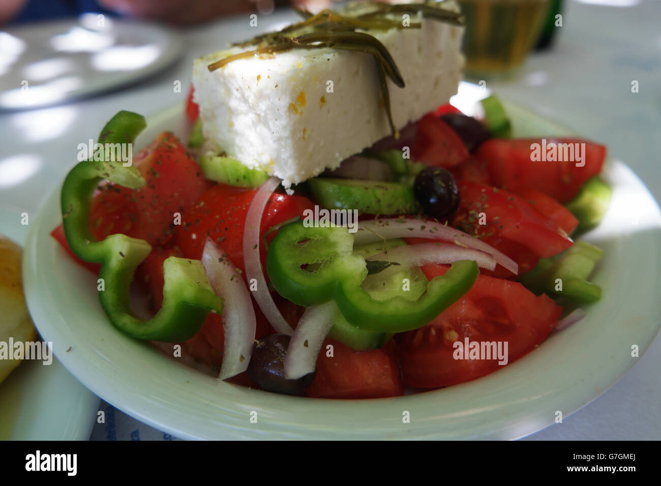 Greek salad, with Feta cheese, shot in a Greek taverna. Stock Photo