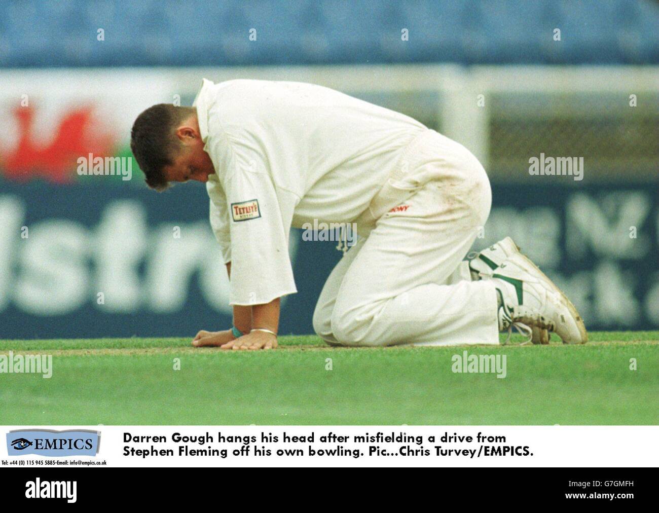 Darren Gough hangs his head after misfielding a drive from Stephen Fleming off his own bowling. Stock Photo