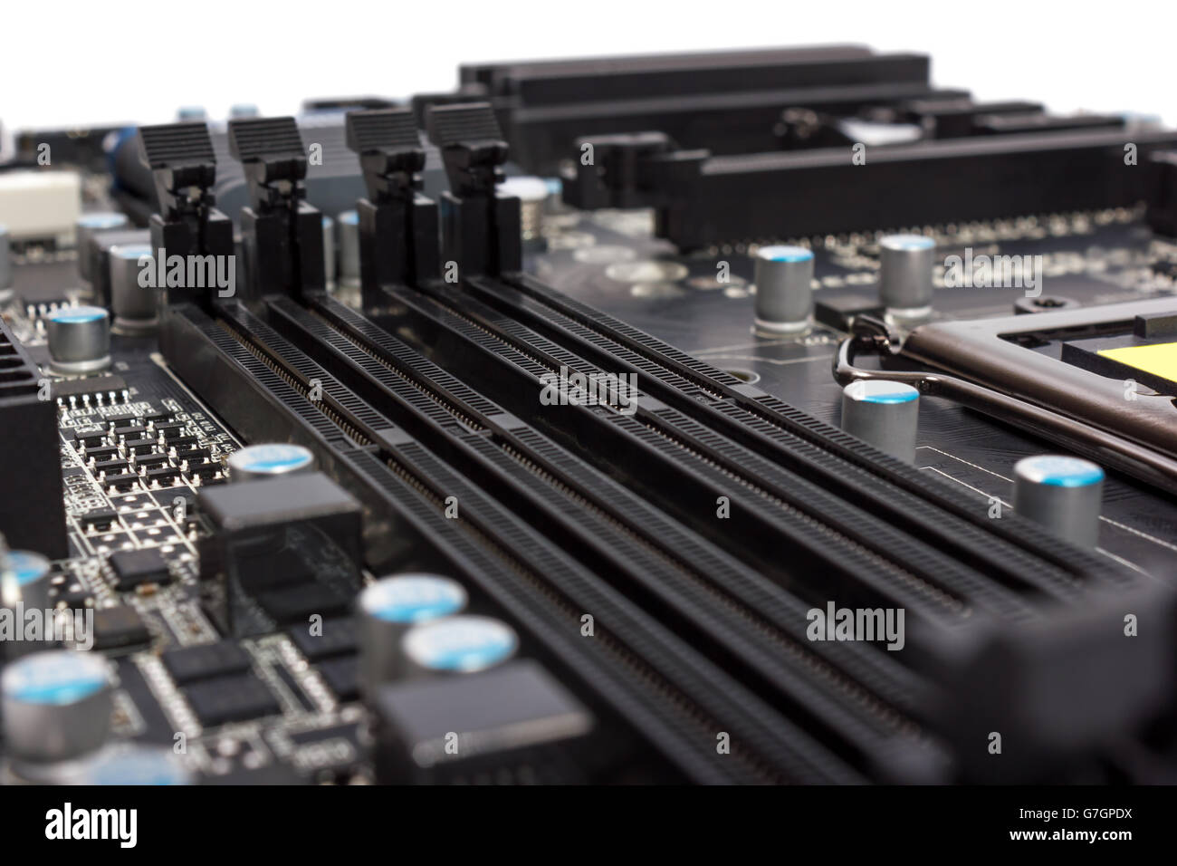 Electronics components on modern PC computer motherboard with RAM connector slot Stock Photo