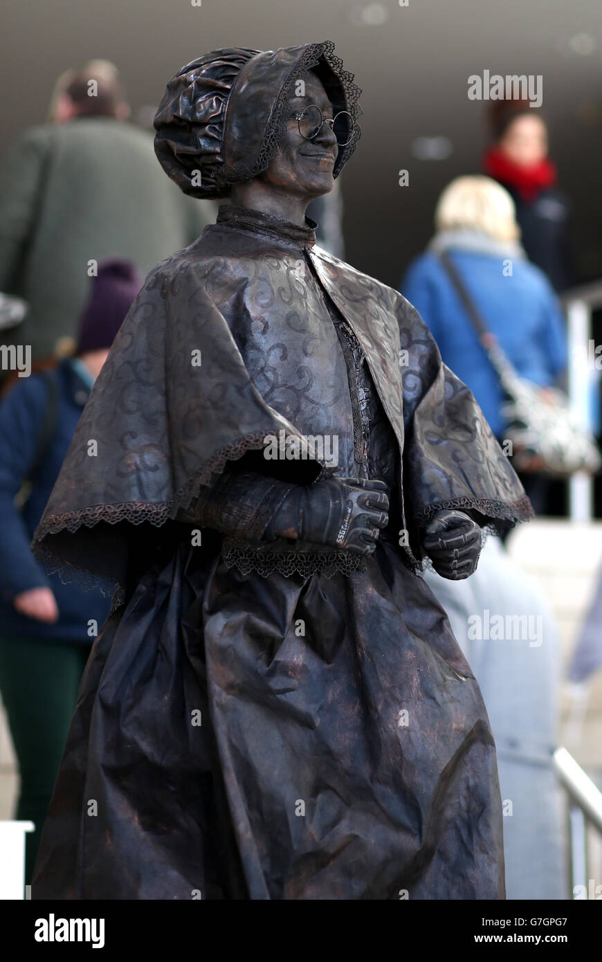 People look at a bronze human statue in the entrance foyer at Sandown