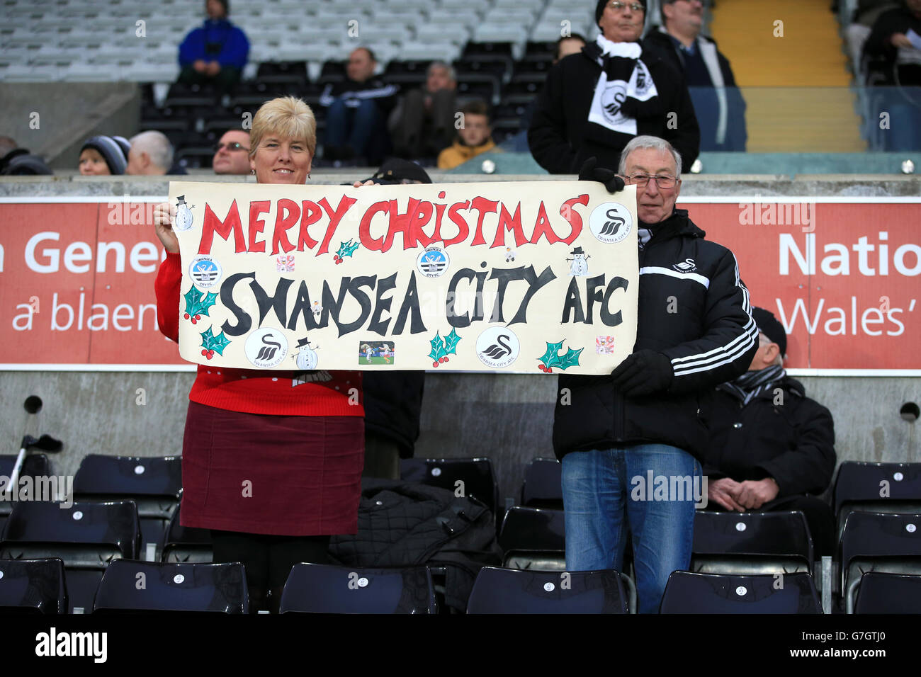 Swansea City fans with a message of seasonal good will in the stands before the Barclays Premier League match at the Liberty Stadium, Swansea. Stock Photo