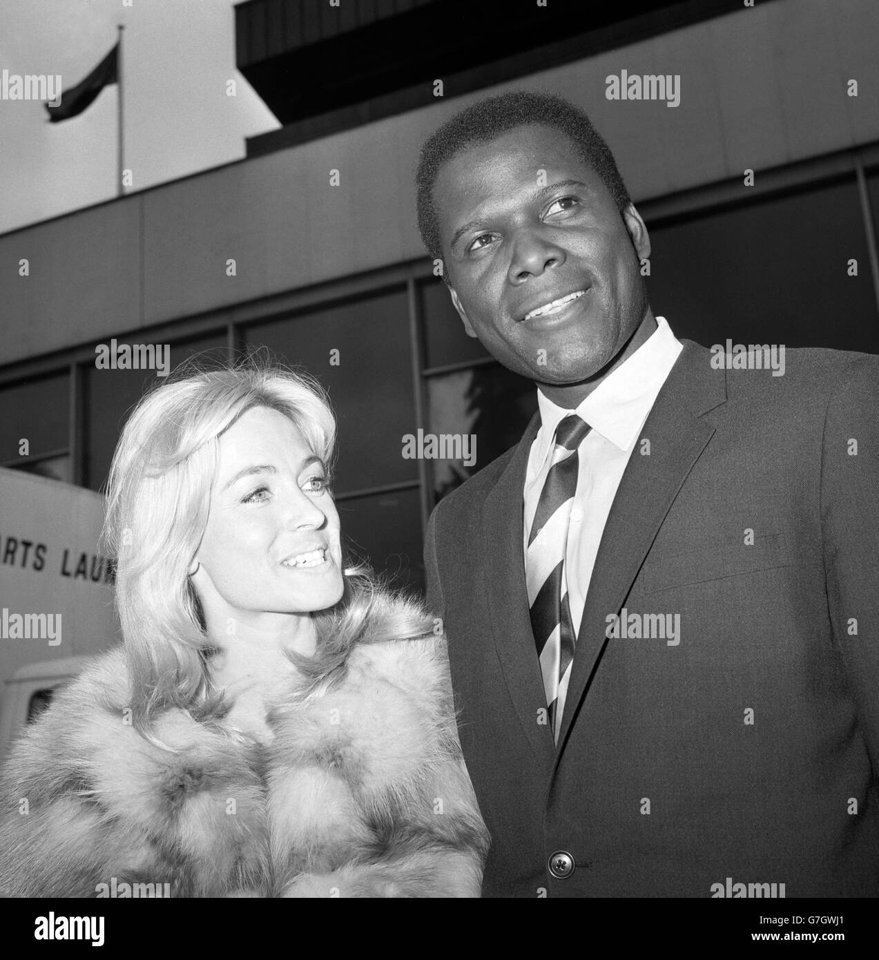 Oscar-winning actor Sidney Poitier is met at London Airport by Suzy Kendall, who will star with him in the film To Sir, With Love. Both play teachers in a tough London school in the movie, which will go into production at Pinewood Studios. Stock Photo