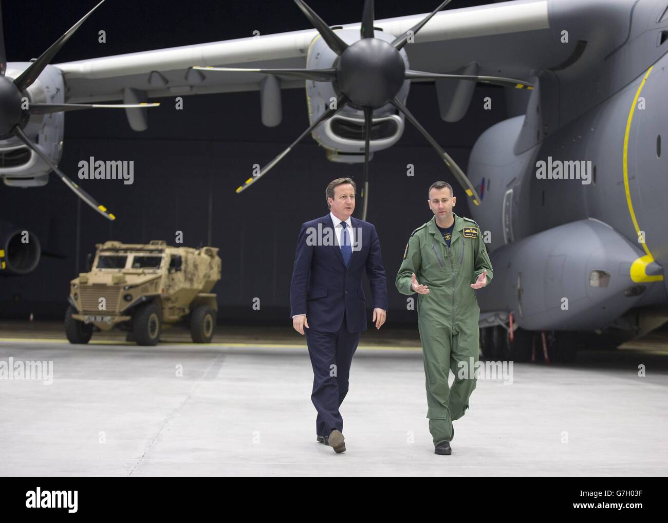 Prime Minister David Cameron views a newly delivered A400M Atlas aircraft with wing commander Simon Boyle (right) at RAF Brize Norton, England. Stock Photo
