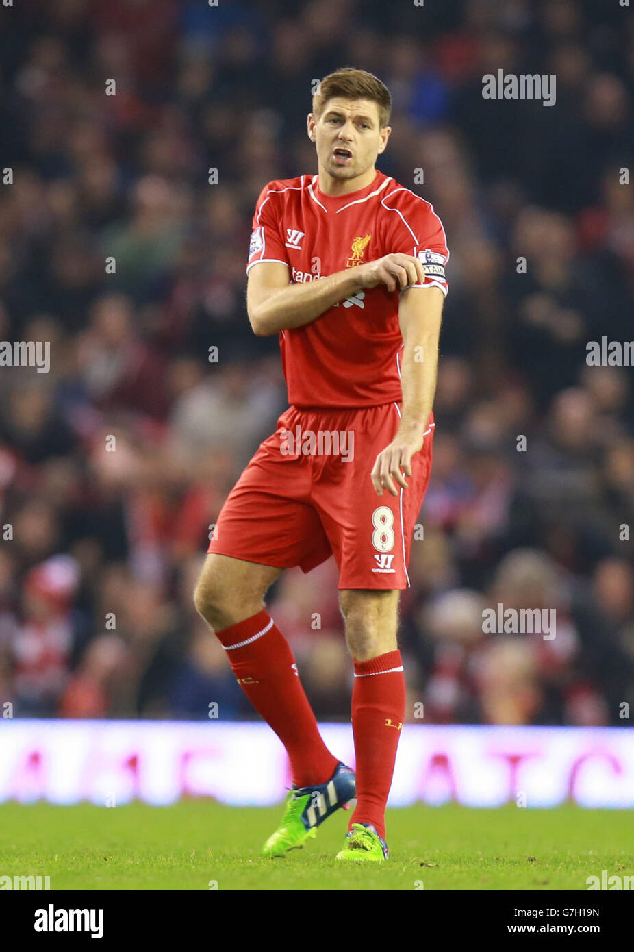 Liverpool's Steven Gerrard pulls on the captains arm band during the  Barclays Premier League match at Anfield, Liverpool Stock Photo - Alamy