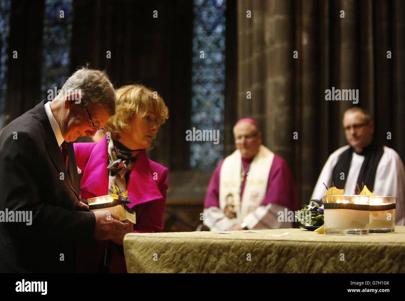 Family representatives light a candle commemorating for one of the ten victims who lost their lives in the Clutha helicopter crash, during a service of remembrance at Glasgow Cathedral. Stock Photo