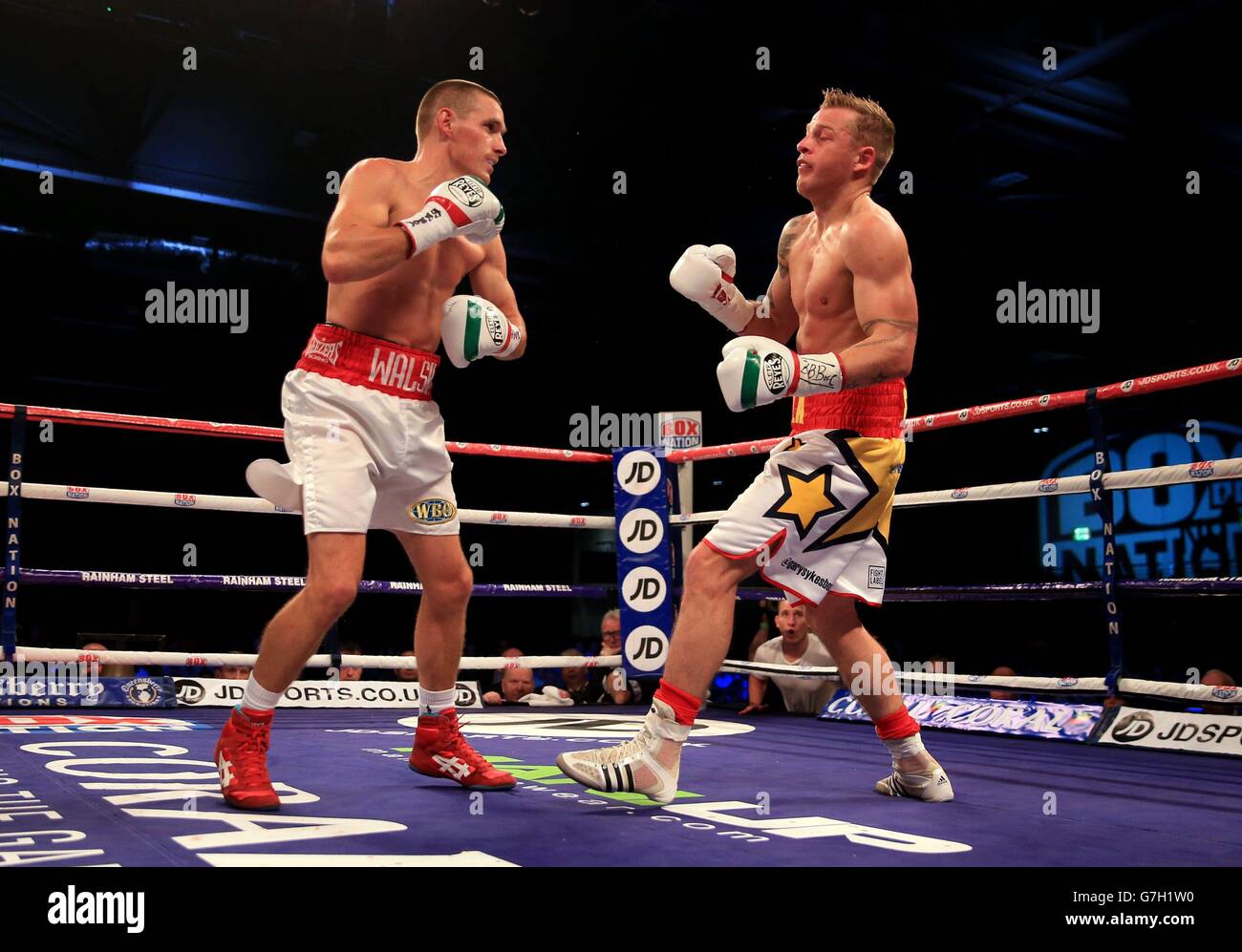 Gary Sykes (right) in action against Liam Walsh during their British and Commonwealth super featherweight titles fight at the ExCel Arena, London. Stock Photo